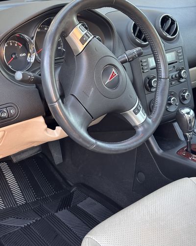 Clean Pontiac G6 interior with cream leather and dark dash